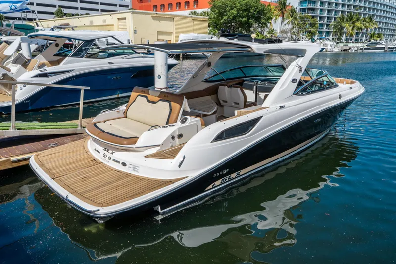 Slide: The Image of 2015 Sea Ray 350 SLX luxury boat docked in marina, featuring sleek design and spacious seating. - 4