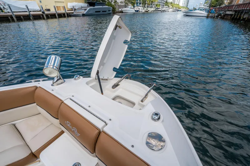 Slide: The Image of 2015 Sea Ray 350 SLX boat on water, open hatch, luxurious seating, docked nearby. - 42