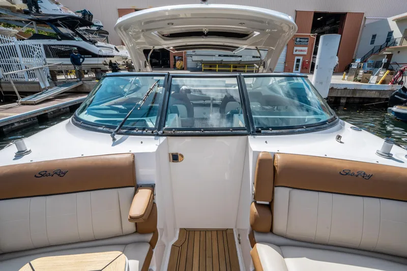 Slide: The Image of 2015 Sea Ray 350 SLX boat interior with tan seating at a marina. - 44
