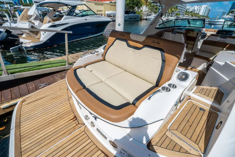 Slide: The Image of 2015 Sea Ray 350 SLX luxury boat with spacious seating at a marina dock. - 9