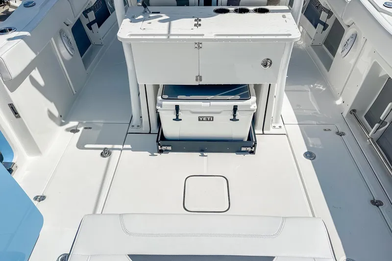 Slide: The Image of 2023 Blackfin 302CC boat interior with Yeti cooler and storage area. - 10