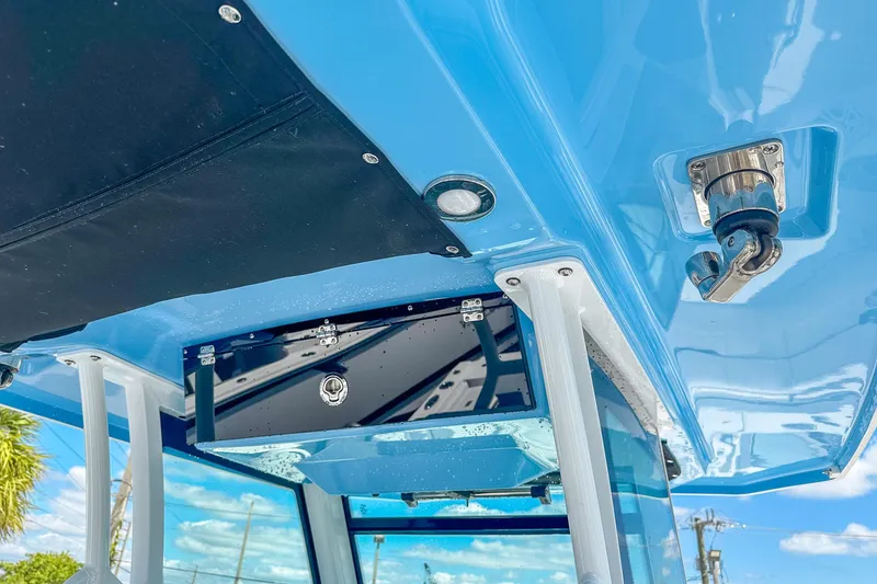 Slide: The Image of 2023 Blackfin 302CC boat interior, featuring sleek blue design and stainless steel hardware. - 15