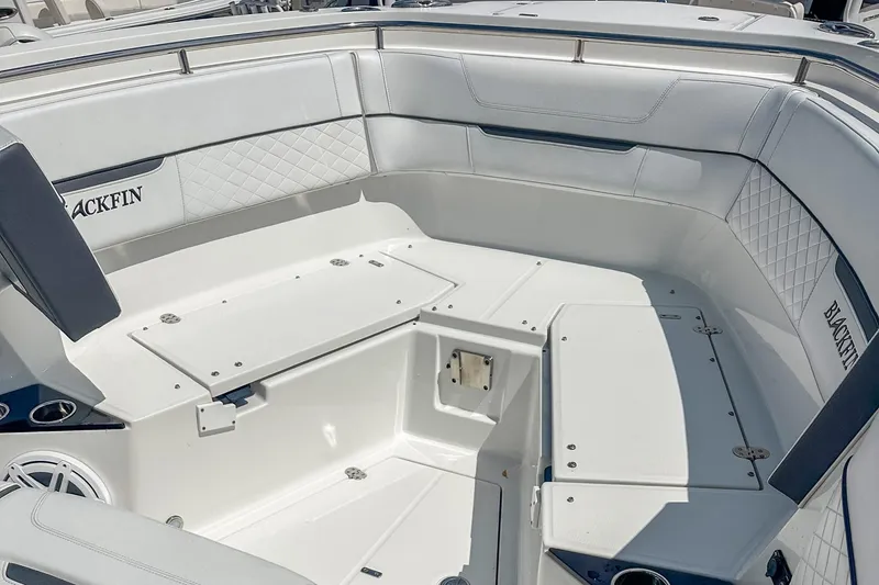 Slide: The Image of 2023 Blackfin 302CC boat interior with white seating and storage compartments. - 17