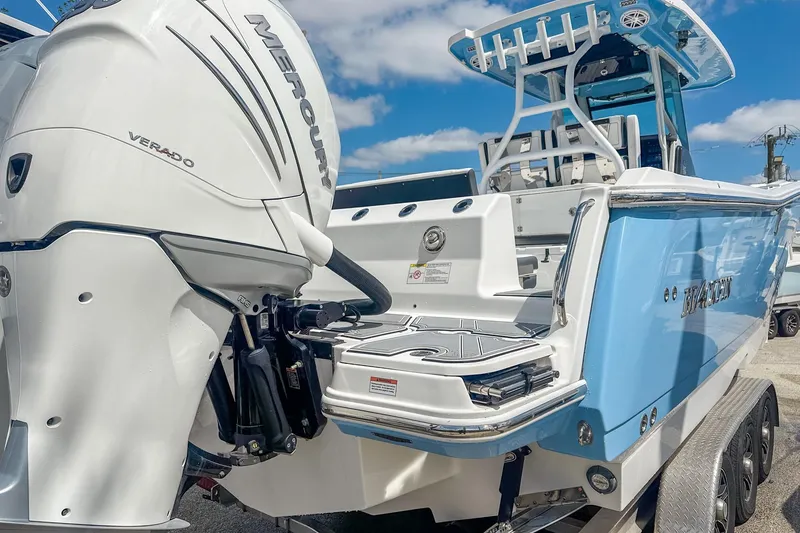 Slide: The Image of 2023 Blackfin 302CC boat with Mercury Verado engine, blue and white design. - 5