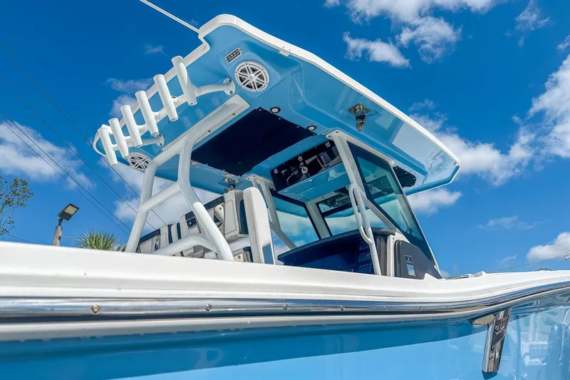 Slide: The Image of 2023 Blackfin 302CC boat against a clear blue sky, showcasing sleek design and modern features. - 6