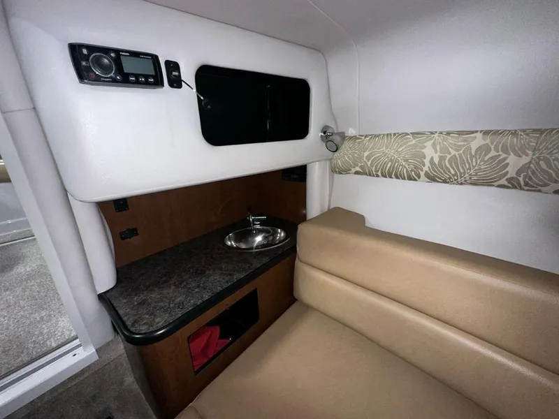 Slide: The Image of Interior of 2015 Crownline 236 SC boat with sink, seating, and storage. - 12