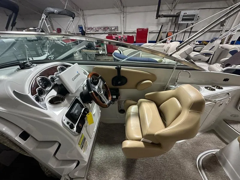 Slide: The Image of Interior of a 2015 Crownline 236 SC boat with beige seating and Garmin navigation. - 16