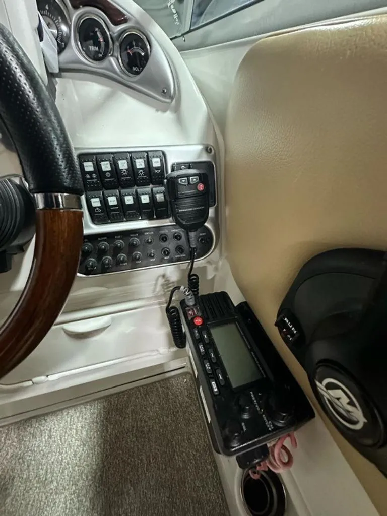 Slide: The Image of Interior dashboard of a 2015 Crownline 236 SC boat with controls and radio equipment. - 18
