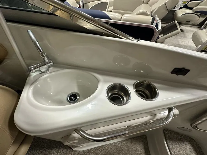 Slide: The Image of 2015 Crownline 236 SC boat interior with sink and cup holders. - 22