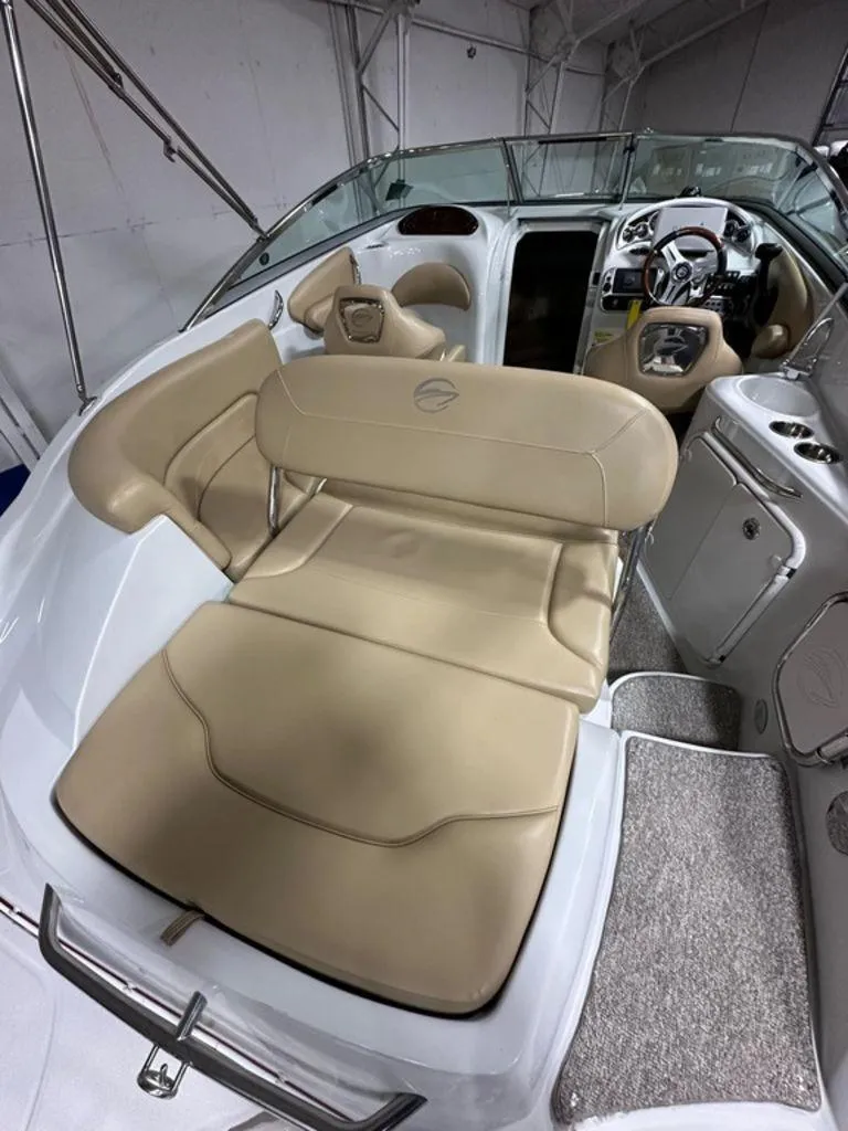 Slide: The Image of 2015 Crownline 236 SC boat interior with beige seating and steering console. - 24