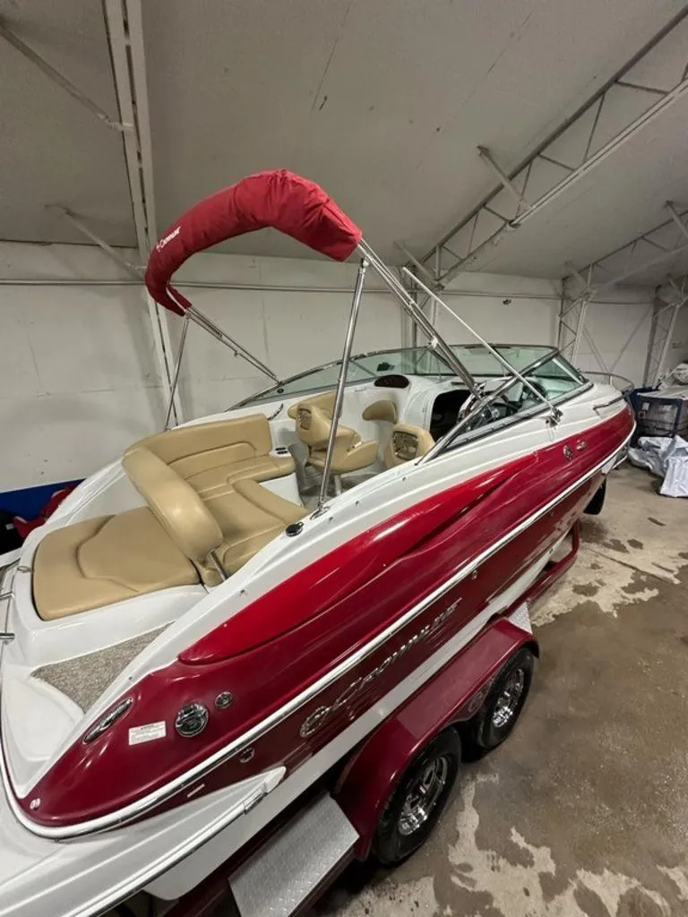 Slide: The Image of 2015 Crownline 236 SC boat with red and white exterior, beige interior, in a storage facility. - 3