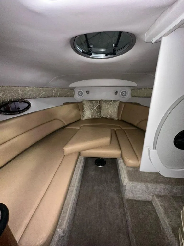 Slide: The Image of 2015 Crownline 236 SC cabin interior with beige seating and circular skylight. - 9
