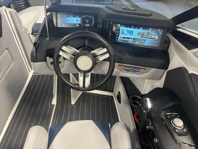Slide: The Image of 2022 Nautique G25 Paragon boat cockpit with modern steering and digital displays. - 10