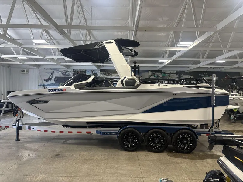Slide: The Image of 2022 Nautique G25 Paragon boat on trailer in indoor showroom. - 3