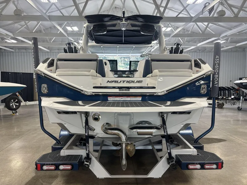 Slide: The Image of 2022 Nautique G25 Paragon boat in showroom, rear view showcasing sleek design and features. - 4