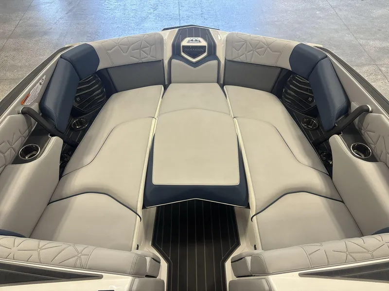 Slide: The Image of 2022 Nautique G25 Paragon boat interior with luxurious seating and cup holders. - 6