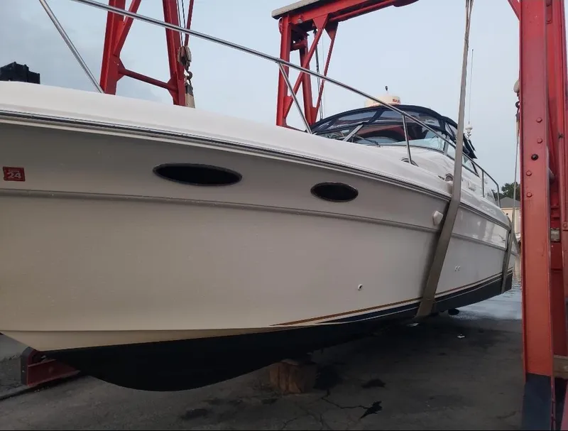 Slide: The Image of 1999 Sea Ray 330 Sundancer boat suspended on a lift, side view. - 5