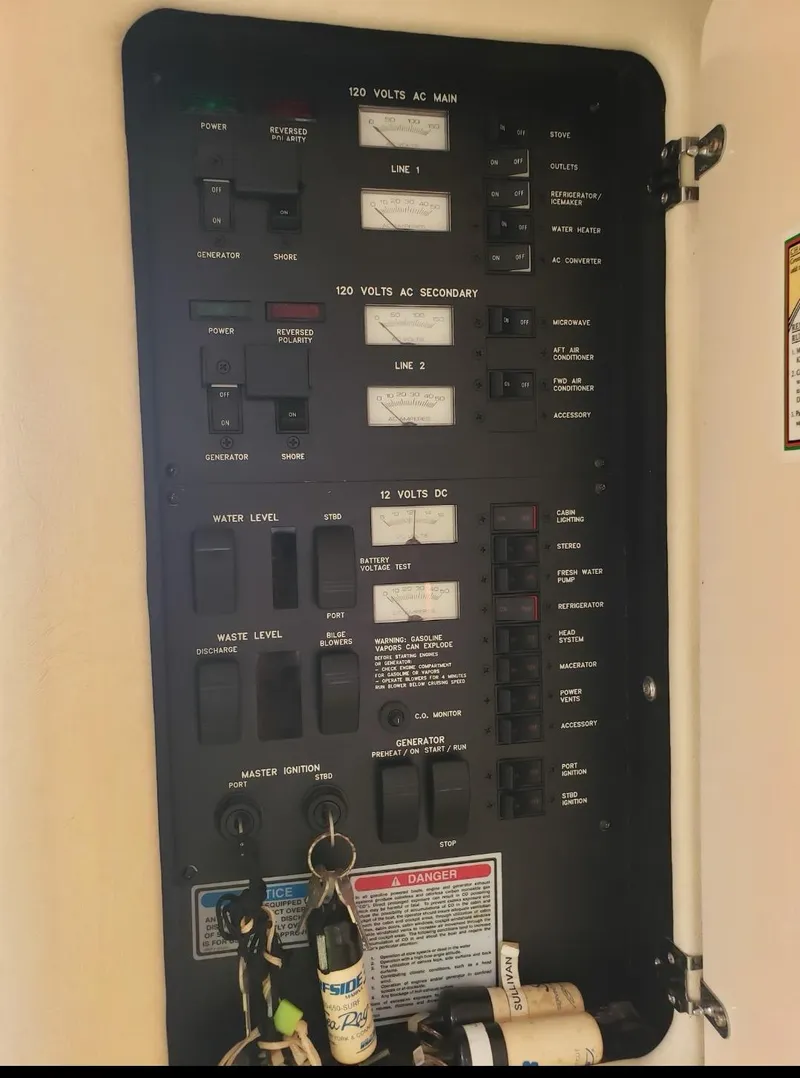 Slide: The Image of Electrical panel of a 1999 Sea Ray 330 Sundancer boat, showing various switches and gauges. - 7