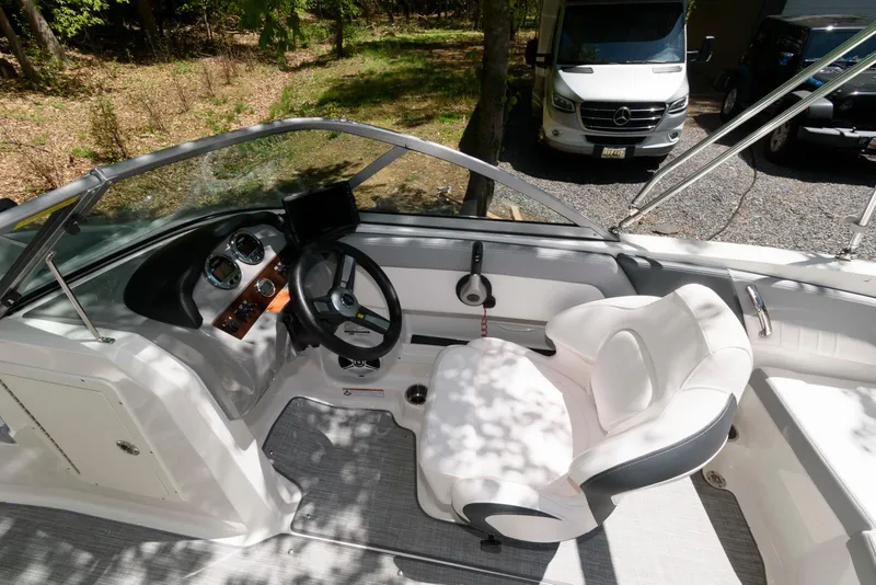Slide: The Image of 2020 Chaparral 19 SSi OB boat interior with steering wheel and seating. - 5