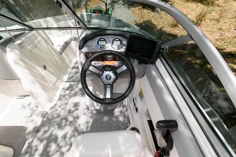 Slide: The Image of 2020 Chaparral 19 SSi OB boat cockpit with steering wheel and dashboard controls. - 6