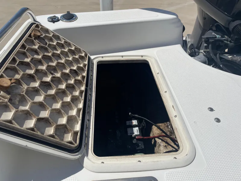 Slide: The Image of Open hatch on 2003 Baystealth 2230 boat showing battery compartment. - 11