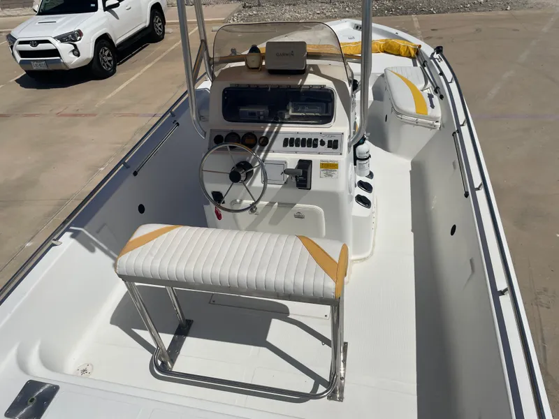 Slide: The Image of 2003 Baystealth 2230 boat interior with steering console and seating. - 12
