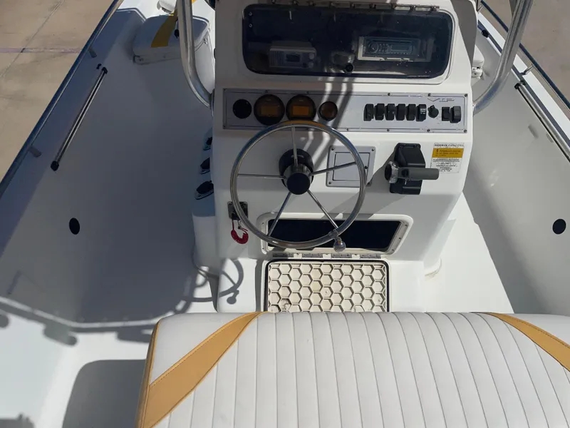 Slide: The Image of 2003 Baystealth 2230 boat console with steering wheel and control panel. - 17