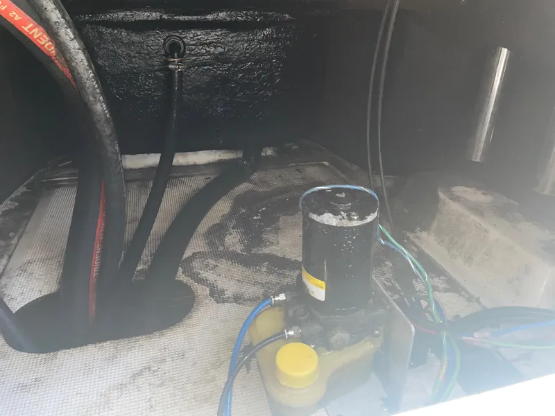 Slide: The Image of Bilge area of a 2003 Baystealth 2230 boat with hoses and pump. - 18