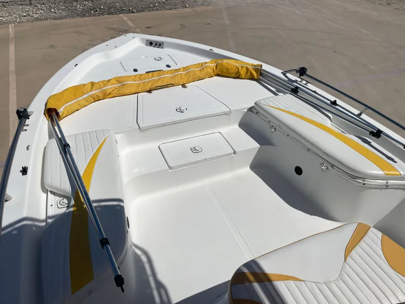 Slide: The Image of 2003 Baystealth 2230 boat interior with white and yellow seating, spacious deck, and storage compartments. - 21