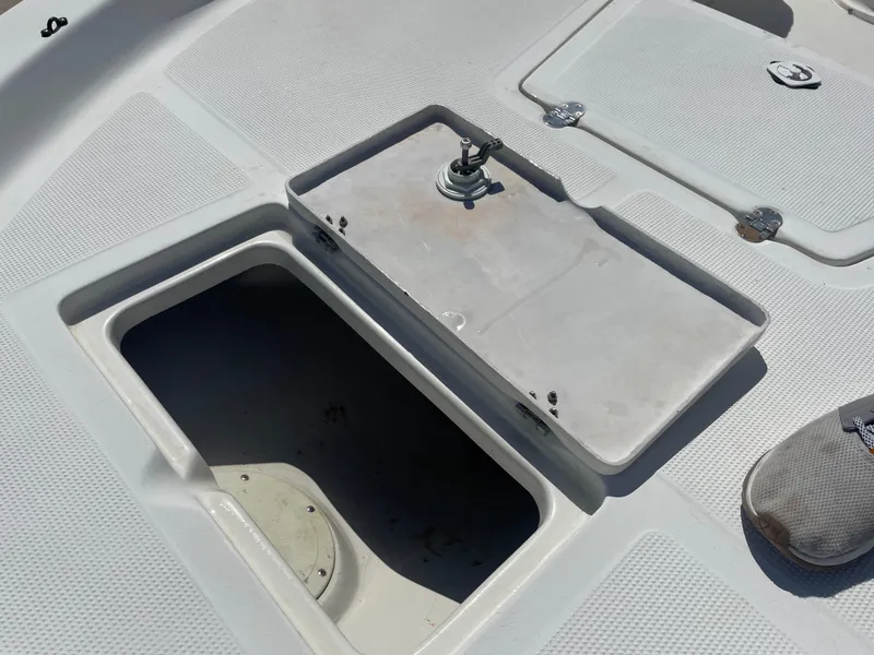 Slide: The Image of Open storage compartment on a 2003 Baystealth 2230 boat deck. - 25