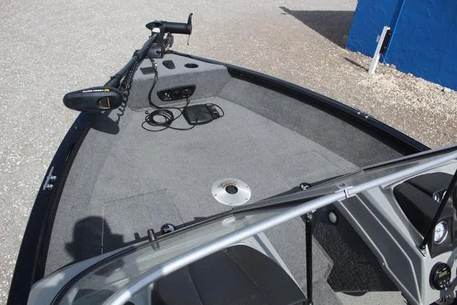 Slide: The Image of 2019 Tracker Pro Guide V-165 WT boat interior with trolling motor and carpeted deck. - 14