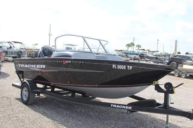 Slide: The Image of 2019 Tracker Pro Guide™ V-165 WT boat on trailer, parked outdoors. - 3