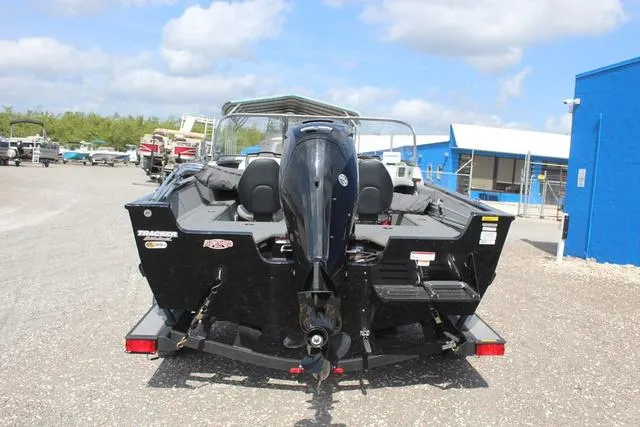 Slide: The Image of 2019 Tracker Pro Guide V-165 WT boat, rear view, parked outdoors on a sunny day. - 5