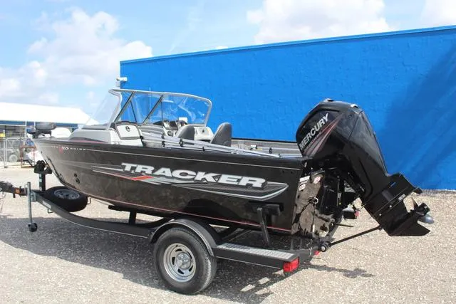 Slide: The Image of 2019 Tracker Pro Guide V-165 WT boat with Mercury engine on trailer, parked outdoors. - 6