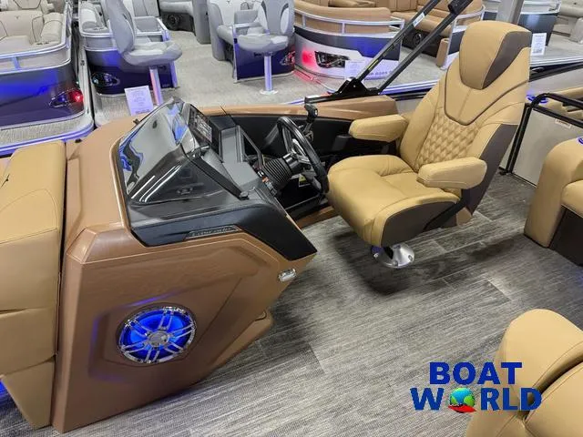 Slide: The Image of 2025 Tahoe Cascade 2385 Tritoon interior with luxury seating and modern dashboard at Boat World. - 11