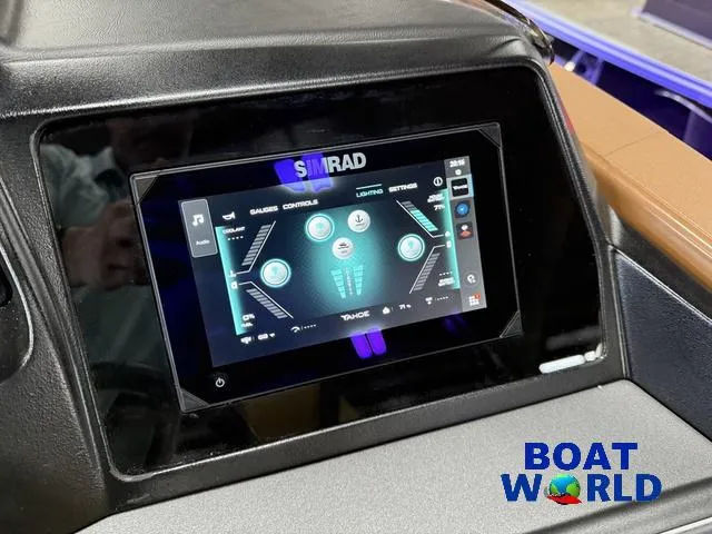 Slide: The Image of Simrad touchscreen on 2025 Tahoe Cascade 2385 Swingback Tritoon dashboard, featuring control interface. - 16