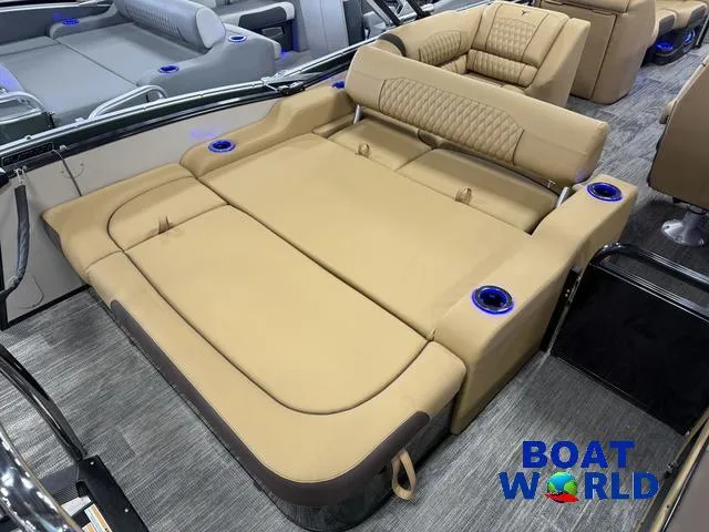 Slide: The Image of 2025 Tahoe Cascade 2385 Swingback Tritoon interior with tan seating and cup holders. - 20
