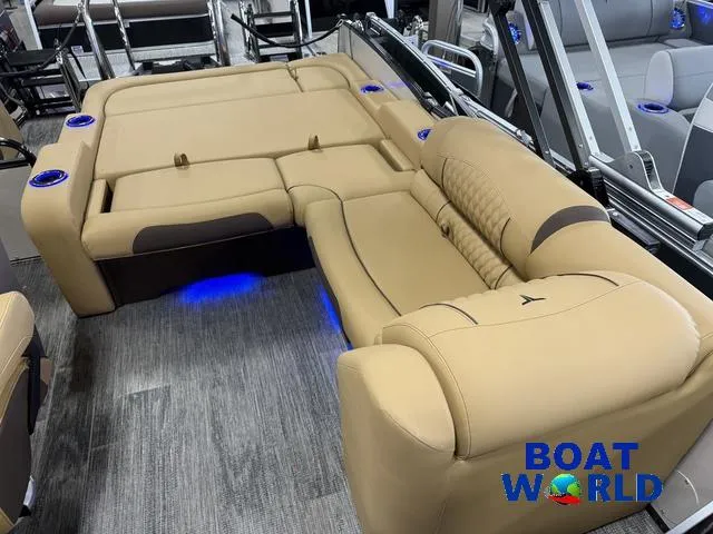 Slide: The Image of 2025 Tahoe Cascade 2385 Tritoon interior with tan seating and blue LED lighting. - 21