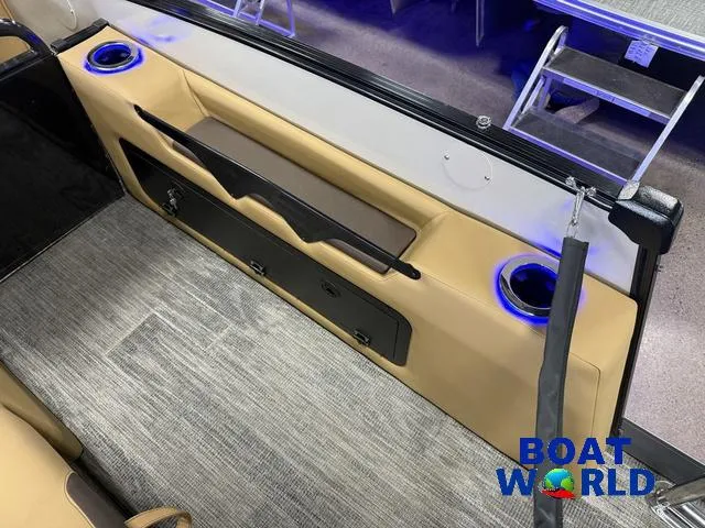 Slide: The Image of 2025 Tahoe Cascade 2385 Tritoon interior with cup holders and seating, showcased at Boat World. - 24