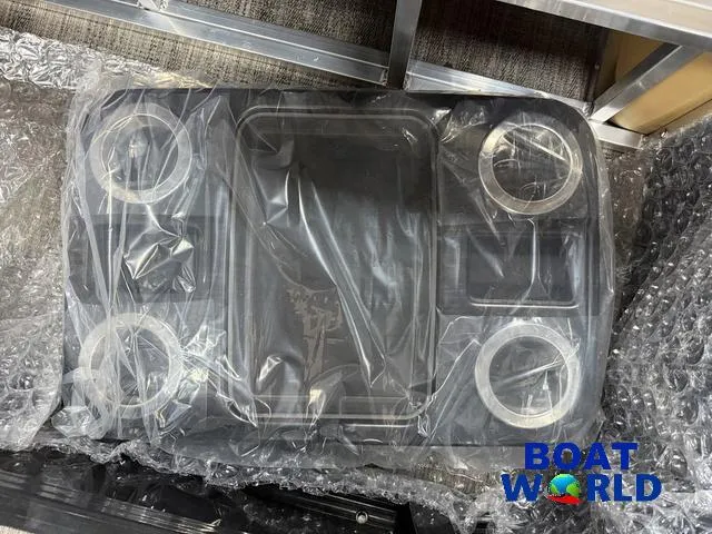 Slide: The Image of Plastic-wrapped boat accessory for 2025 Tahoe Cascade 2385 Swingback Tritoon at Boat World. - 25