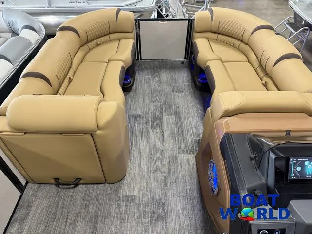 Slide: The Image of 2025 Tahoe Cascade 2385 Tritoon interior with tan seating and modern dashboard. - 31