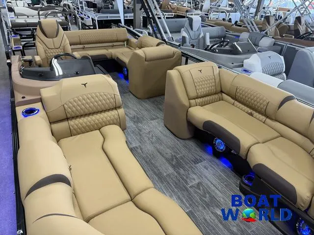 Slide: The Image of Luxurious interior of 2025 Tahoe Cascade 2385 Swingback Tritoon with plush seating and ambient lighting. - 35