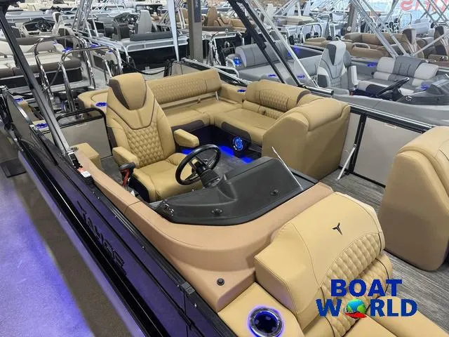 Slide: The Image of 2025 Tahoe Cascade 2385 Tritoon with luxurious seating at Boat World showroom. - 4
