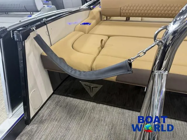 Slide: The Image of 2025 Tahoe Cascade 2385 Swingback Tritoon interior with tan seating and safety features. - 47
