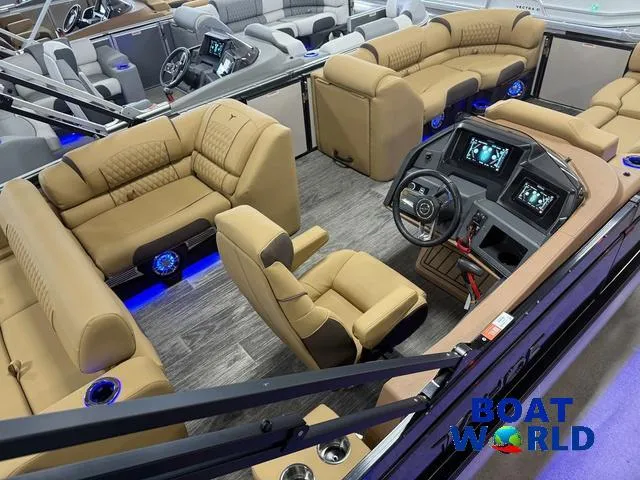 Slide: The Image of Luxurious interior of 2025 Tahoe Cascade 2385 Swingback Tritoon with modern dashboard and seating. - 5