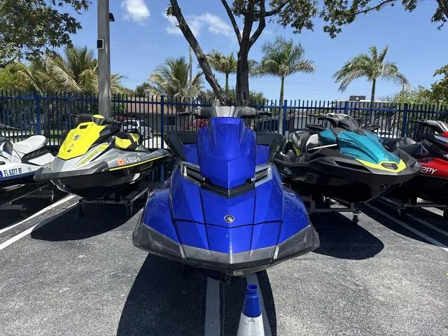 Slide: The Image of 2014 Yamaha WaveRunner FX HO in blue, parked with other jet skis under palm trees. - 3