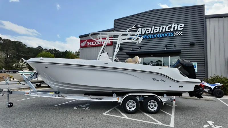 Slide: The Image of 2025 Bayliner Trophy 24 CC boat on trailer at Avalanche Motorsports dealership. - 0