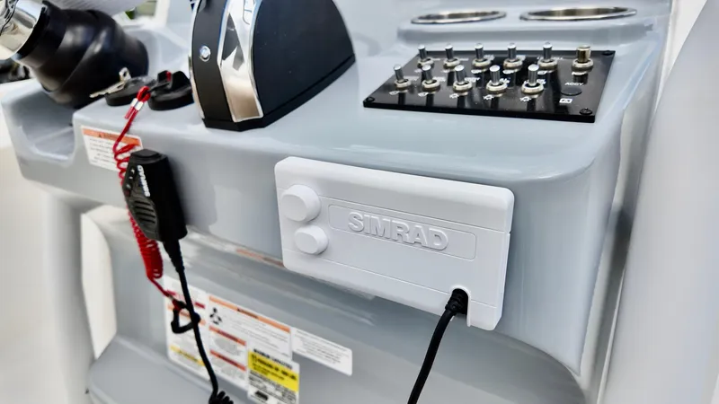 Slide: The Image of Control panel of 2025 Bayliner Trophy 24 CC boat with Simrad electronics. - 10