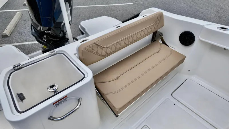 Slide: The Image of 2025 Bayliner Trophy 24 CC boat interior with beige seating and storage compartment. - 13