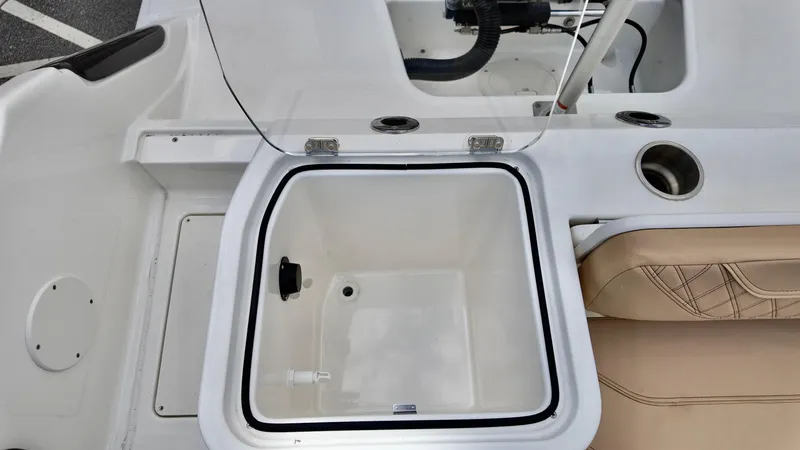 Slide: The Image of 2025 Bayliner Trophy 24 CC boat interior with open storage compartment and seating. - 14